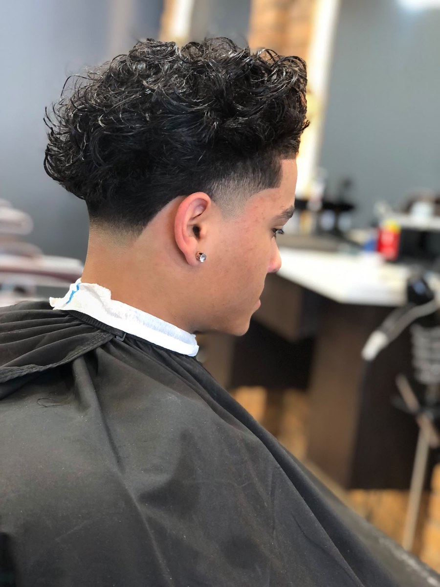 Curly haircut with tapered sides at Kasbah Barber