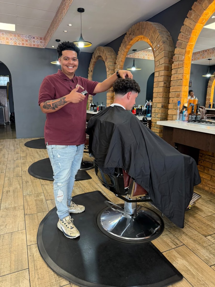 Kasbah barber beside a client in the shop