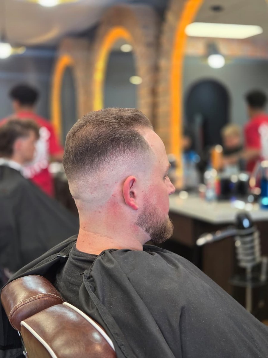 Short fade haircut, rear side view at Kasbah Barber